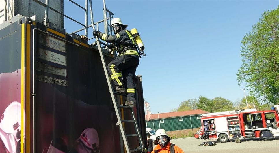 Die Kameraden steigen über den Dacheinstieg in die Brandsimulationsanlage.  Foto: khe