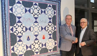 Respekt für eine filigrane Handarbeit: Im Namen der Samtgemeinde Selsingen bedankte sich Samtgemeindebürgermeister Gerhard Kahrs bei Martin Grubert (r.) für das vorweihnachtliche Geschenk. Der von ihm und seiner Frau Anette hergestellte Quilt hat einen festen Platz im Rathaus gefunden. Foto: ue