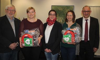 Von links: Johann Steffens und Alicia Burmester aus Klenkendorf sowie Nadine Zehmke-Kahrs und Julia Fischer aus Barchel freuen sich über einen Defibrillator. Überreicht wurde er von Volksbank-Mitarbeiter Sascha Ringe.  Foto: im