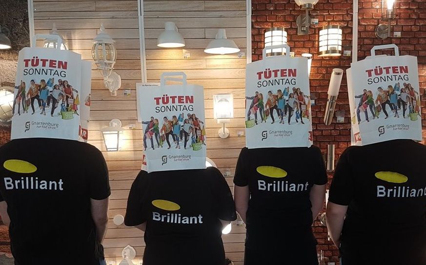 Stecken die Köpfe nur fürs Bild in die Tüte: In Wirklichkeit beweises die Mitarbeiter*innen bei Brilliant helles Kundenberatungsköpfchen. Foto: eb