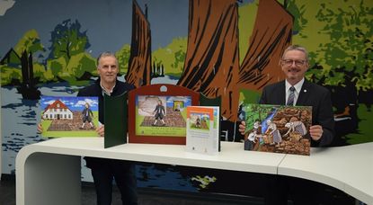 Hans-Hinrich Kahrs (links) und Landrat Bernd Lütjen präsentieren das Kamishibai-Erzähltheater zur Geschichte von Jürgen Christian Findorff.