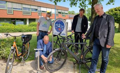 Unter den kritischen Blicken von Schulleiter Wilhelm Windmann, BBS-Umweltbeauftragtem Frank Helmes und Initiator Andreas Fuhrken „betankt“ Jürgen Grimm, Koordinator Qualitätsmanagement an der BBS, erstmals das Fahrrad des Schulleiters an der neuen Lufttankstelle. Foto: nek
