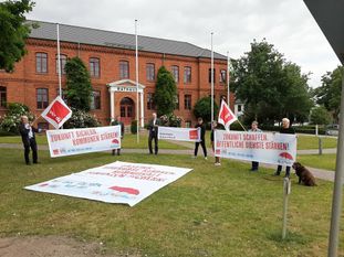 Mit Transparenten machten Mitglieder von ver.di und der Linken gemeinsam mit Bürgermeister Torsten Rohde auf ihre Forderungen nach mehr Geld für die Kommunen aufmerksam. Foto: eb