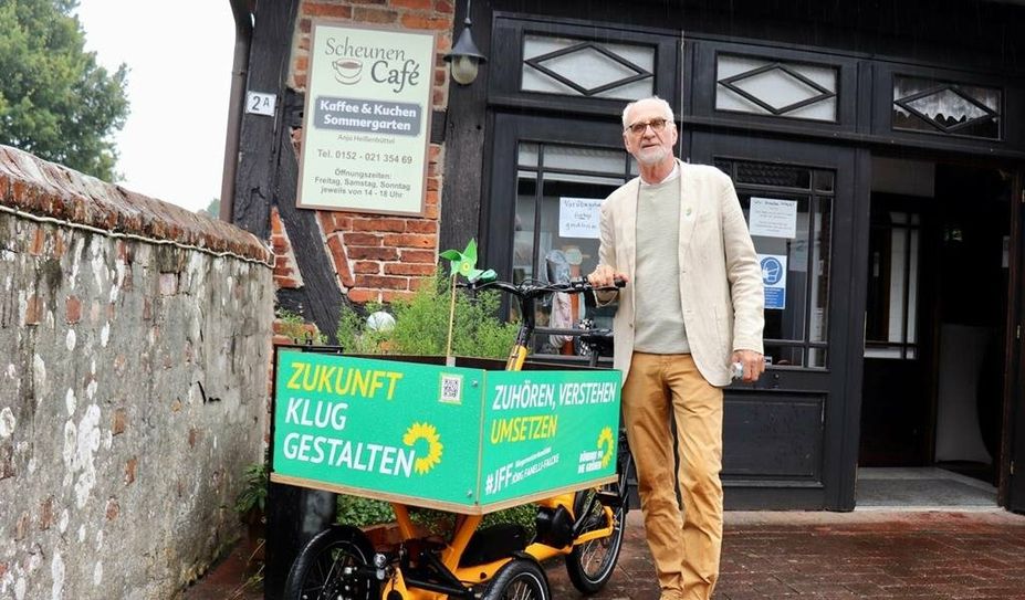 Der grüne Bürgermeisterkandidat Jörg Fanelli-Falcke mit seinem Wahlkampfmobil vor dem Scheunen Cafe in Osterholz.