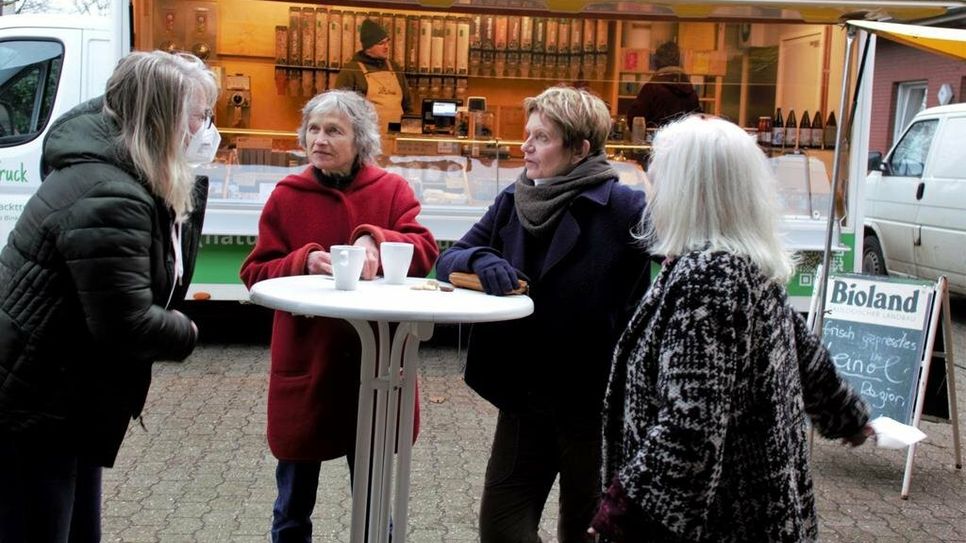 V. r.: Brunhild Fischer-Ritzenhoff, Helga Gorges und Helga Stienecke tauschen sich mit einer Marktbeschickerin aus.