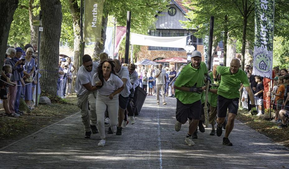 Ein besonderer Höhepunkt: das Torfkahn-Wettziehen. Hier treten Mannschaften gegeneinander an und ziehen historische Torfkähne mit vereinten Kräften über die Klinker der Lindenallee.