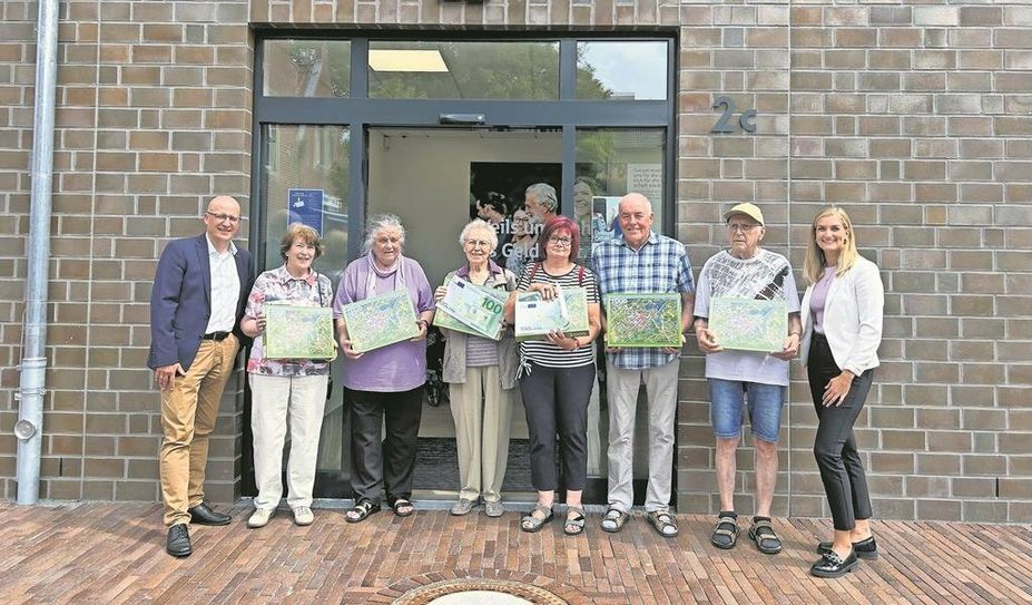 Die glücklichen Gewinner:innen mit Geschäftsstellenleiter Volker Stahmann (links) und Kundenberaterin Alena Renken (rechts).