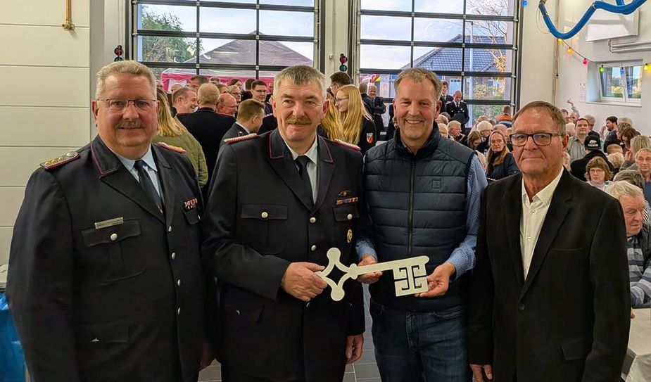 (v. l.) Gemeindebrandmeister Ralf Meyer, Ortsbrandmeister Stefan Adrian, Bürgermeister Guido Dieckmann und Ortsvorsteher Herbert Lührs bei der symbolischen Schlüsselübergabe.