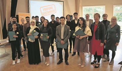 Alle Absolventinnen präsentieren stolz ihr Abschlusszeugnis.