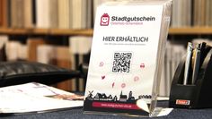 Wichtiger Impuls für den Handel vor Ort: Der Stadtgutschein ist online und in teilnehmenden Geschäften erhältlich.